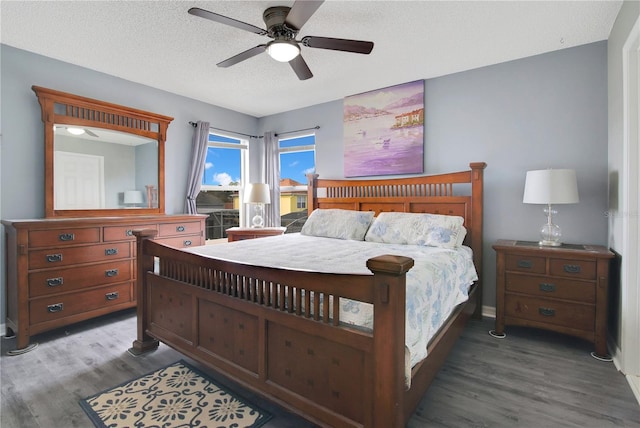 bedroom featuring a textured ceiling, wood-type flooring, and ceiling fan