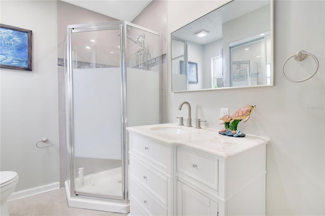 bathroom featuring toilet, tile patterned flooring, vanity, and a shower with door