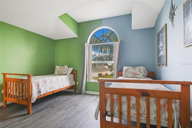 bedroom with hardwood / wood-style flooring and a textured ceiling