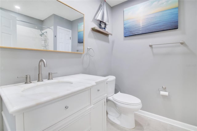 bathroom with vanity, tile patterned flooring, toilet, and walk in shower