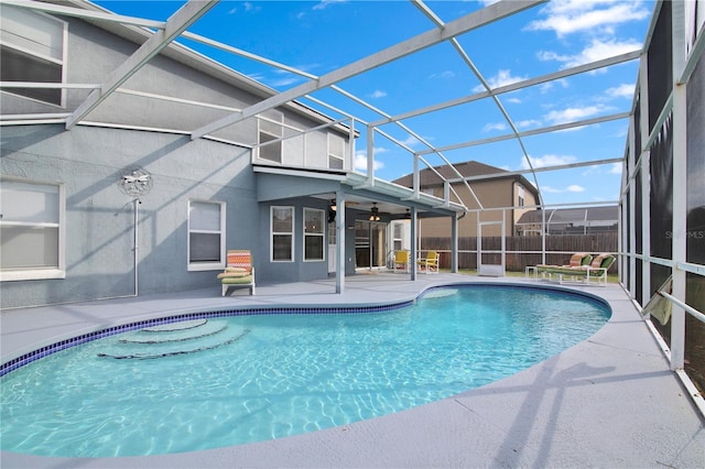 view of pool with a patio, a lanai, and ceiling fan