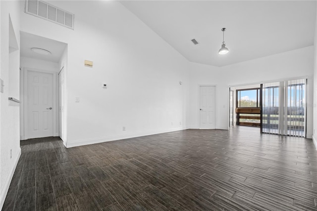 unfurnished room featuring high vaulted ceiling and dark hardwood / wood-style floors