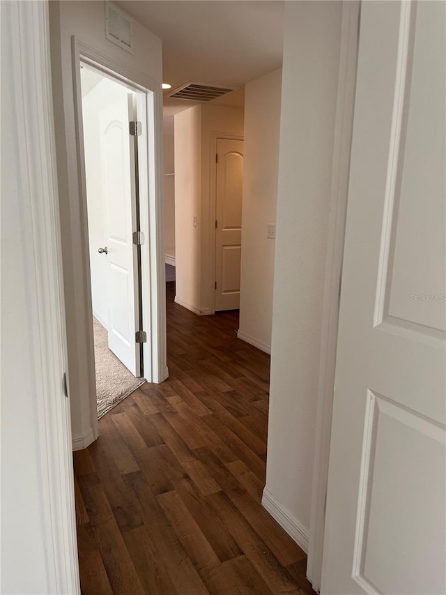 corridor with dark wood-type flooring