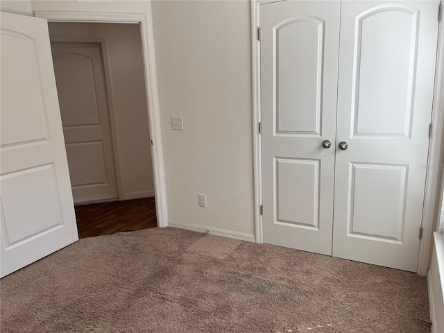 unfurnished bedroom featuring a closet and carpet floors