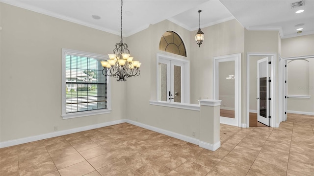 spare room featuring french doors, a notable chandelier, and ornamental molding