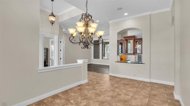 unfurnished dining area featuring an inviting chandelier, tile patterned floors, and ornamental molding