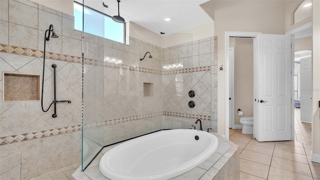 bathroom featuring tile patterned floors, shower with separate bathtub, and toilet