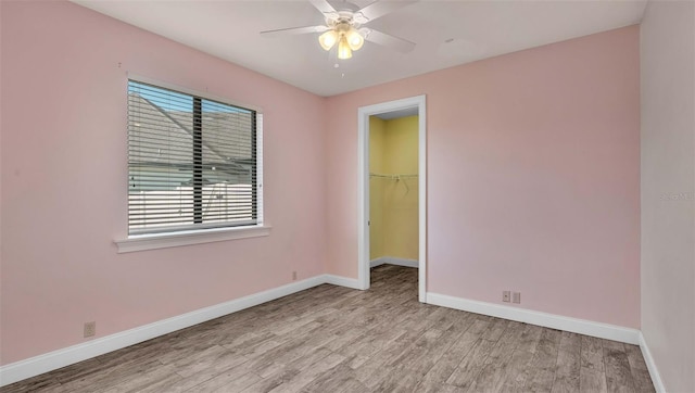 empty room featuring ceiling fan and light hardwood / wood-style floors