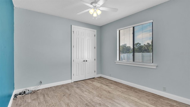 unfurnished room with light wood-type flooring and ceiling fan