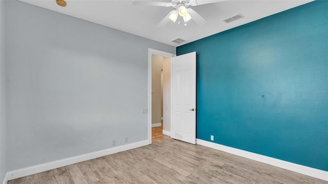 empty room featuring ceiling fan and light hardwood / wood-style flooring