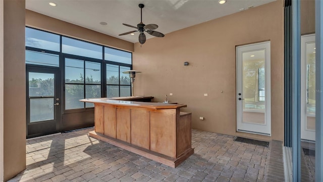 interior space with ceiling fan