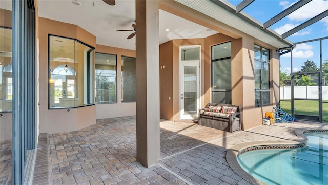 unfurnished sunroom with a jacuzzi, a skylight, and ceiling fan