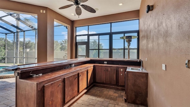 bar featuring sink and ceiling fan