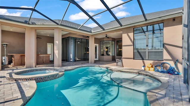 view of swimming pool with an in ground hot tub, a patio, glass enclosure, and ceiling fan