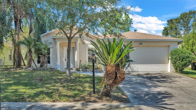 view of front of house featuring a front yard and a garage