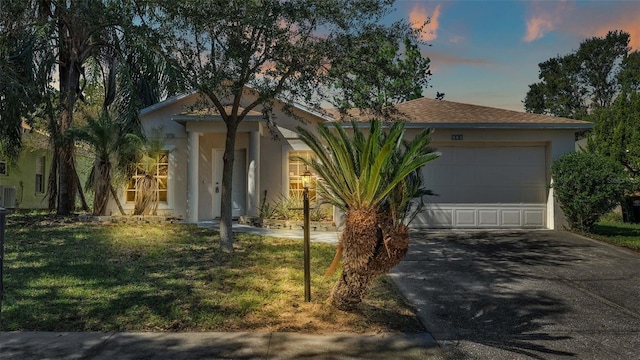 view of front of house featuring a yard and a garage