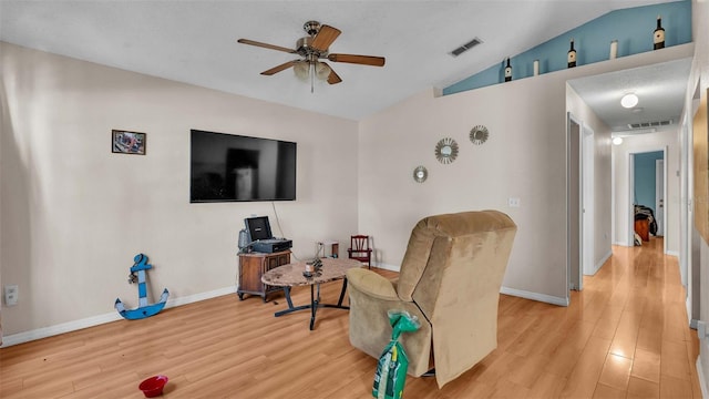 interior space featuring vaulted ceiling, light hardwood / wood-style floors, and ceiling fan