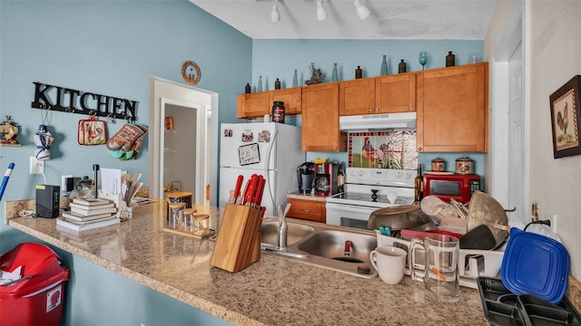 kitchen with vaulted ceiling, a textured ceiling, and white appliances