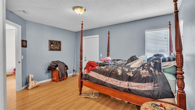 bedroom featuring a textured ceiling and hardwood / wood-style floors