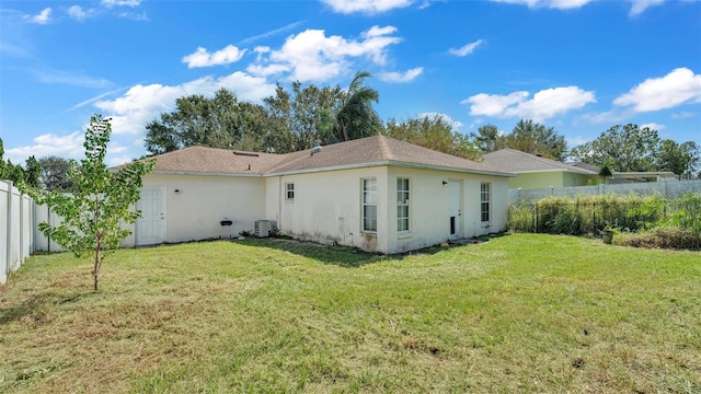 back of house with a lawn