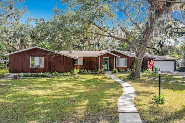 single story home featuring a front lawn and a garage