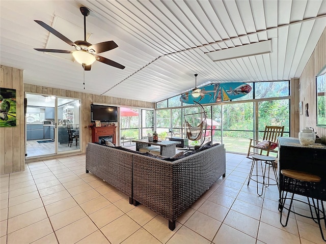 sunroom featuring ceiling fan, a healthy amount of sunlight, vaulted ceiling, and wood ceiling