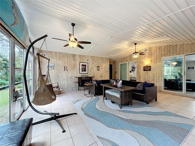 interior space featuring ceiling fan, wooden ceiling, light tile patterned flooring, and wooden walls