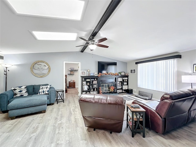 living room with lofted ceiling with beams, light wood-type flooring, and ceiling fan