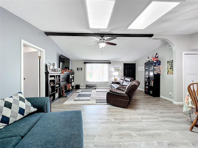 living room featuring vaulted ceiling with beams, light hardwood / wood-style flooring, and ceiling fan