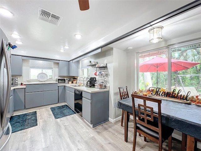 kitchen featuring sink, appliances with stainless steel finishes, light hardwood / wood-style flooring, and a healthy amount of sunlight