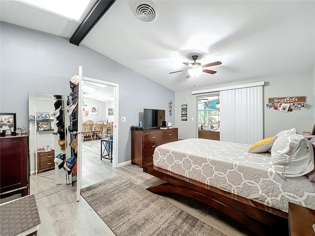 bedroom featuring light hardwood / wood-style flooring, lofted ceiling with beams, and ceiling fan