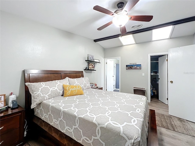 bedroom featuring vaulted ceiling, wood-type flooring, and ceiling fan