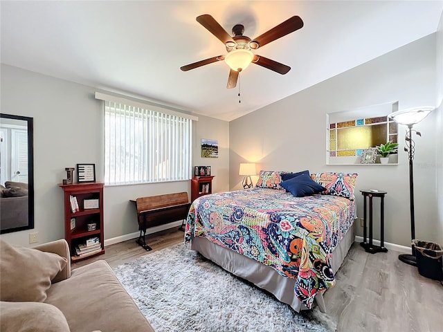 bedroom featuring vaulted ceiling, light wood-type flooring, and ceiling fan