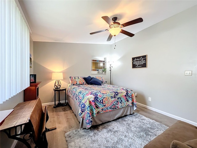 bedroom with light hardwood / wood-style flooring, lofted ceiling, and ceiling fan