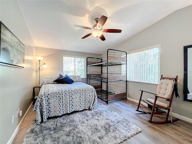 bedroom featuring lofted ceiling, hardwood / wood-style flooring, and ceiling fan