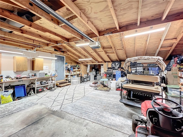 interior space with a workshop area, lofted ceiling, and concrete flooring