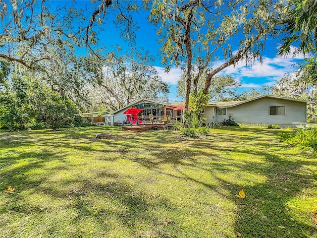 view of yard with a wooden deck