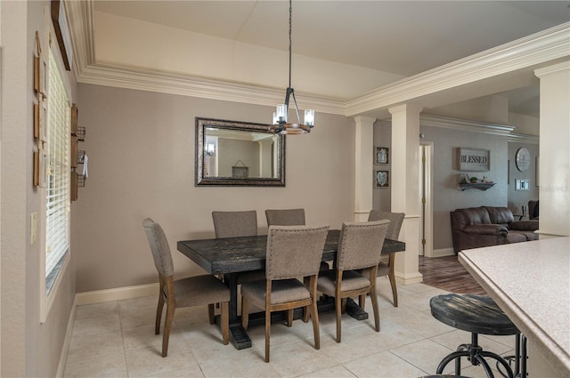 dining area featuring ornate columns, crown molding, a chandelier, light tile patterned floors, and a raised ceiling