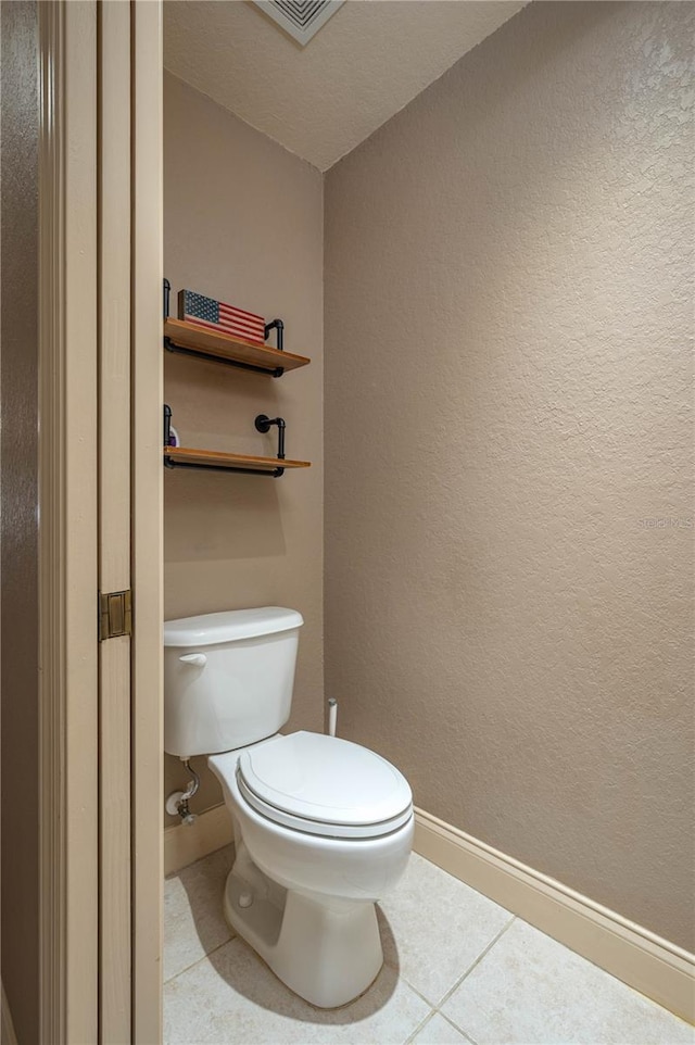 bathroom featuring tile patterned floors and toilet