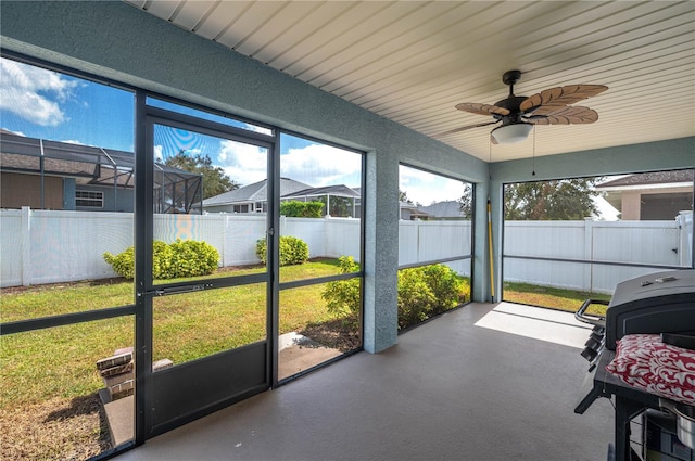 sunroom / solarium featuring a wealth of natural light and ceiling fan