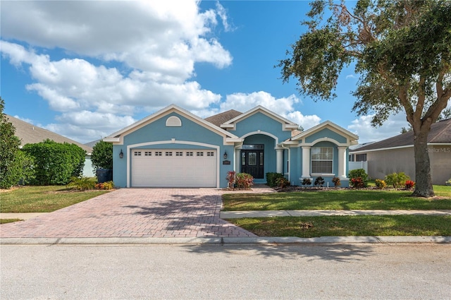 ranch-style home featuring a garage and a front yard