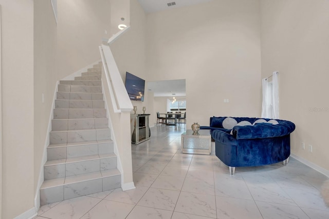 staircase featuring a towering ceiling