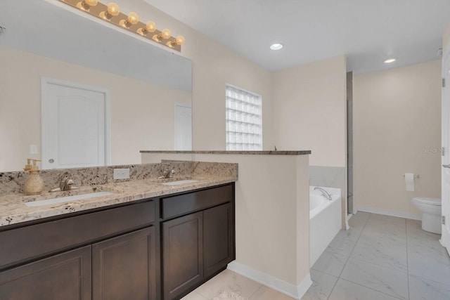 bathroom featuring vanity, a bathtub, and toilet