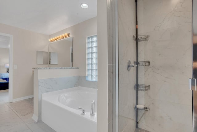 bathroom featuring shower with separate bathtub