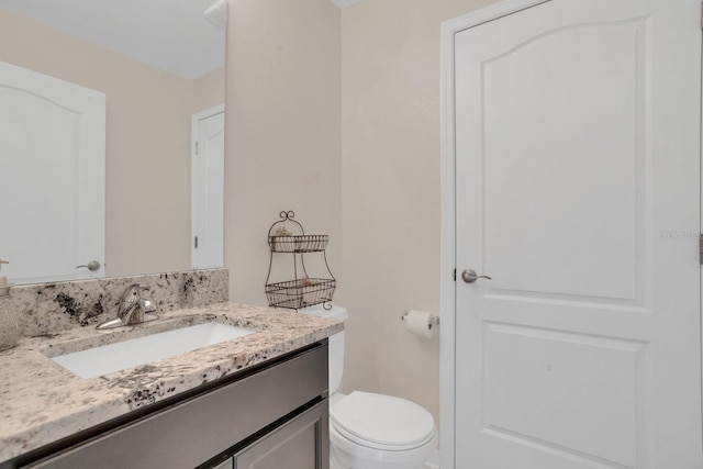 bathroom with vanity and toilet