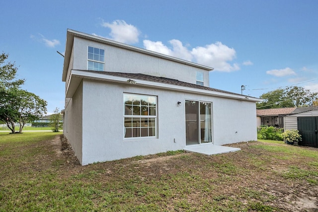 rear view of property featuring a lawn