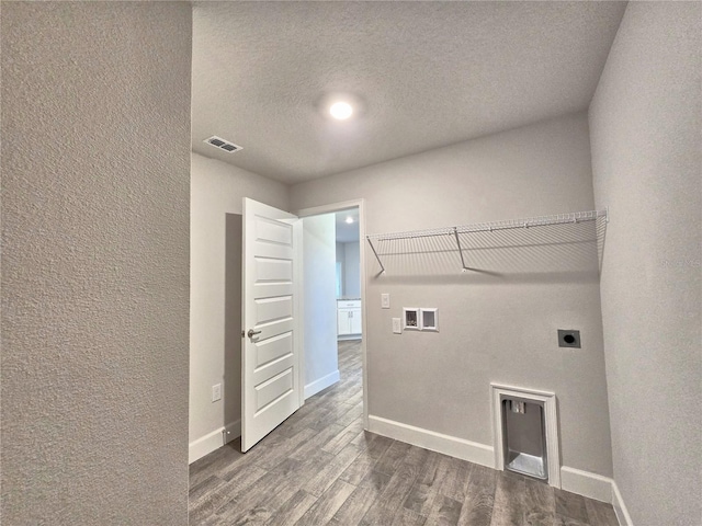 washroom with visible vents, baseboards, laundry area, dark wood-type flooring, and electric dryer hookup
