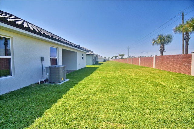 view of yard featuring cooling unit and fence