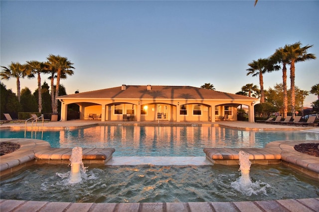 pool featuring a community hot tub and a patio