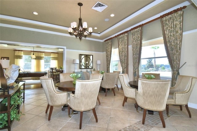 tiled dining space with visible vents, ornamental molding, recessed lighting, a tray ceiling, and an inviting chandelier
